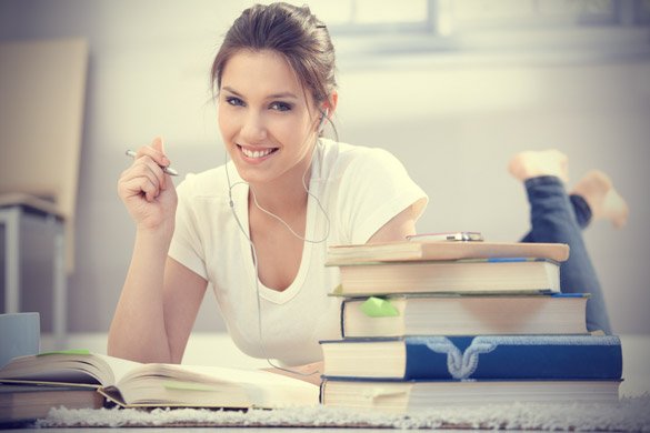 attractive college girl learning at home on floor
